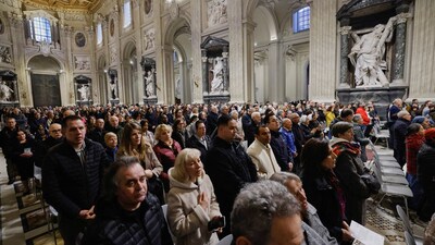 People gather to pray for Pope Francis, who is in critical condition battling double pneumonia, inside Archcathedral of Saint John in Lateran (REUTERS)