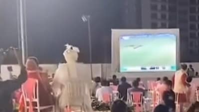 In the video, the bride and groom can be seen seated on two chairs on the chairs facing a large screen. (X/@JaikyYadav16) In the video, the bride and groom can be seen seated on two chairs on the chairs facing a large screen. (X/@JaikyYadav16)