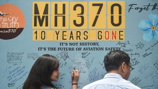 A woman writes a message during an event held by relatives of the passengers and supporters to mark the 10th year since the Malaysia Airlines flight MH370 carrying 239 people disappeared from radar screens on March 8, 2014 while en route from Kuala Lumpur to Beijing, in Subang Jaya on March 3, 2024. (AFP)