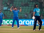 Afghanistan's Gulbadin Naib, center, celebrates after taking the wicket of England's Liam Livingstone