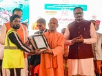 Prayagraj: UP CM Yogi Adityanath felicitates a municipal worker during the closing ceremony a day after the conclusion of Maha Kumbh 2025, in Prayagraj, Thursday, Feb. 27, 2025. Prayagraj: UP CM Yogi Adityanath felicitates a municipal worker during the closing ceremony a day after the conclusion of Maha Kumbh 2025, in Prayagraj, Thursday, Feb. 27, 2025.