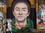 A pedestrian walks past a mural of Luigi Mangione, the suspect in the killing of UnitedHealth Group chief executive Brian Thompson, in East London, Britain February 26, 2025