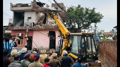 A house linked to a drug peddler being bulldozed in Patiala on Thursday. (HT) A house linked to a drug peddler being bulldozed in Patiala on Thursday. (HT)