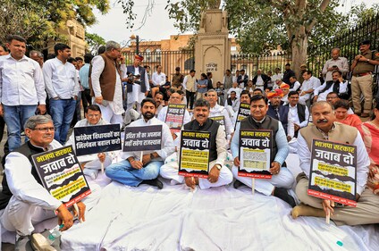 Jaipur: Rajasthan Congress President Govind Singh Dotasra, Leader of Opposition Tikaram Jully and party MLAs sit on dharna as they protest outside the state Assembly against suspension of their MLAs from the Assembly and against a state minister's alleged remarks against former prime minister Indira Gandhi, in Jaipur, Thursday. (PTI) Jaipur: Rajasthan Congress President Govind Singh Dotasra, Leader of Opposition Tikaram Jully and party MLAs sit on dharna as they protest outside the state Assembly against suspension of their MLAs from the Assembly and against a state minister's alleged remarks against former prime minister Indira Gandhi, in Jaipur, Thursday. (PTI)