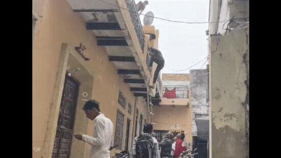 A boy jumping the wall of a government school in Nuh’s Mewat on Thursday. (Video grab)