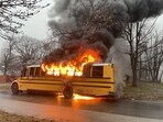The image shows a school bus on fire that was carrying 15 students. All were rescued. The image shows a school bus on fire that was carrying 15 students. All were rescued.