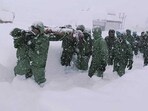 In this handout photo supplied by the Indian Army, a team carries out rescue operations for trapped construction workers who were swept away by an avalanche near the Mana Pass in Chamoli district of Uttarakhand. 