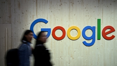 People walk next to a Google logo during a trade fair in Hannover Messe, in Hanover, Germany, April 22, 2024. (Annegret Hilse/Reuters)