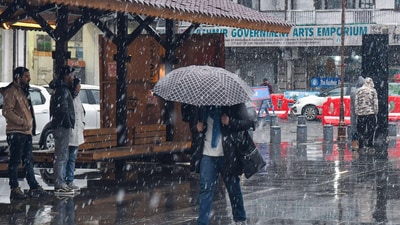 A man shields himself with an umbrella amid fresh snowfall in Srinagar on Thursday. Meanwhile, the Border Roads Organisation (BRO) worked to clear snow from the Srinagar airport runway after continuous rain and snow lashed the region for the past 36 hours, causing a sharp drop in temperature. (ANI) A man shields himself with an umbrella amid fresh snowfall in Srinagar on Thursday. Meanwhile, the Border Roads Organisation (BRO) worked to clear snow from the Srinagar airport runway after continuous rain and snow lashed the region for the past 36 hours, causing a sharp drop in temperature. (ANI)