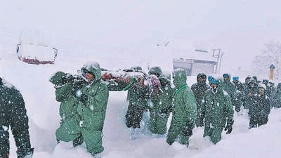 An Indian Army team carries out rescue operations to bring out the trapped construction workers near Mana Pass in Chamoli district of Uttarakhand on Friday. (AP) An Indian Army team carries out rescue operations to bring out the trapped construction workers near Mana Pass in Chamoli district of Uttarakhand on Friday. (AP)