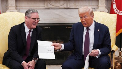 British Prime Minister Keir Starmer hands an invitation from King Charles III to US President Donald Trump at the White House. (AP) British Prime Minister Keir Starmer hands an invitation from King Charles III to US President Donald Trump at the White House. (AP)