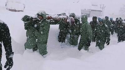 In this photo by the Indian Army, a team carries out rescue operations for trapped construction workers who were swept away by an avalanche near the Mana Village in Chamoli district. (AP) In this photo by the Indian Army, a team carries out rescue operations for trapped construction workers who were swept away by an avalanche near the Mana Village in Chamoli district. (AP)