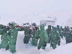 An Indian Army team carries out rescue operations to bring out the trapped construction workers near Mana Pass in Chamoli district of Uttarakhand on Friday. (AP)