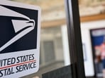 USPS to implement changes to First-Class Mail services aiming to save $36 billion over a decade.
(Photo by Patrick T. Fallon / AFP)