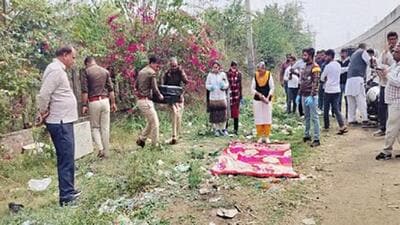 Police and forensic experts at the spot where the suitcase stuffed with the woman’s body was found near Sampla bus stand on the Rohtak-Delhi highway on Saturday.