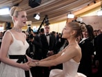 Elle Fanning, left, and Ariana Grande arrive at the Oscars on Sunday.