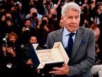 The 76th Cannes Film Festival - Photocall for the film "Indiana Jones and the Dial of Destiny" (Indiana Jones et le cadran de la destinee) Out of Competition - Cannes, France, May 19, 2023. Cast member Harrison Ford holds his Honorary Palme d'Or Award. REUTERS/Yara Nardi
