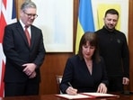Britain's Chancellor of the Exchequer Rachel Reeves, front, signs a document of defence lend for Ukraine on the day she holds a video conference meeting with Ukraine's Finance Minister Sergii Marchenko, as British Prime Minister Keir Starmer, left, and Ukrainian President Volodymyr Zelenskiyy, right, stand in London. Britain's Chancellor of the Exchequer Rachel Reeves, front, signs a document of defence lend for Ukraine on the day she holds a video conference meeting with Ukraine's Finance Minister Sergii Marchenko, as British Prime Minister Keir Starmer, left, and Ukrainian President Volodymyr Zelenskiyy, right, stand in London.