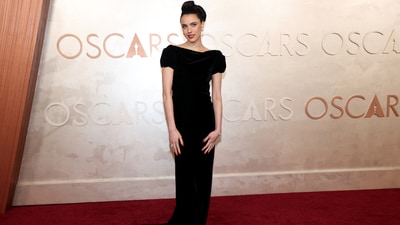 Margaret Qualley poses during the Oscars arrivals at the 97th Academy Awards in head-to-toe Chanel paired with a backwards diamond necklace. The Substance actor is presenting at the Oscars this year, where her costar Demi Moore is up for the Best Actress award.&nbsp; (REUTERS)