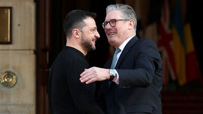 Keir Starmer (R) greets Ukraine's President Volodymyr Zelensky (L) as he arrives to attend a summit held at Lancaster House in central London on March 2, 2025.  (Photo by Toby Melville / POOL / AFP) (AFP)