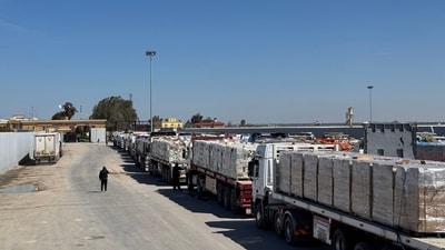 Trucks carrying humanitarian aid line up on the Egyptian side of the Rafah border crossing with the Gaza Strip on March 2, 2025, after Israel suspended the entry of supplies into the Palestinian enclave. (AFP) Trucks carrying humanitarian aid line up on the Egyptian side of the Rafah border crossing with the Gaza Strip on March 2, 2025, after Israel suspended the entry of supplies into the Palestinian enclave. (AFP)