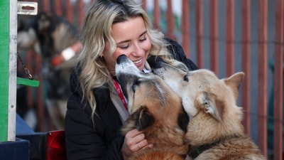 Stephanie Jones, of San Diego, Calif., visits with sled dogs on the team of Justin Olnes (29), of Fairbanks, Alaska, before riding with Olnes in the Ceremonial Start of the Iditarod Trail Sled Dog Race in Anchorage, Alaska. (AP) Stephanie Jones, of San Diego, Calif., visits with sled dogs on the team of Justin Olnes (29), of Fairbanks, Alaska, before riding with Olnes in the Ceremonial Start of the Iditarod Trail Sled Dog Race in Anchorage, Alaska. (AP)