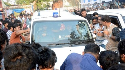Students' Federation of India (SFI) members gather around West Bengal Education Minister Bratya Basu's car at Jadavpur University campus, in Kolkata, Saturday, March 1, 2025. (PTI) Students' Federation of India (SFI) members gather around West Bengal Education Minister Bratya Basu's car at Jadavpur University campus, in Kolkata, Saturday, March 1, 2025. (PTI)