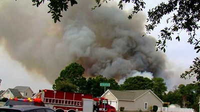 Crews work to contain a fire in the Carolina Forest area west of the coastal resort city of Myrtle Beach, S.C., Sunday, March 2, 2025, where residents were ordered to evacuate several neighborhoods. (AP) Crews work to contain a fire in the Carolina Forest area west of the coastal resort city of Myrtle Beach, S.C., Sunday, March 2, 2025, where residents were ordered to evacuate several neighborhoods. (AP)