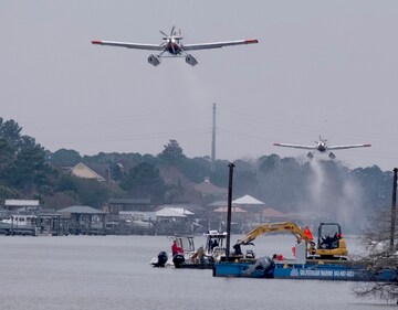 Planes fill bladders with water from the Intracoastal Waterway and empty the water on hot spots in the Carolina Forest wildfire Sunday, March 2, 2025, in Myrtle Beach, S.C. (AP) Planes fill bladders with water from the Intracoastal Waterway and empty the water on hot spots in the Carolina Forest wildfire Sunday, March 2, 2025, in Myrtle Beach, S.C. (AP)