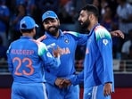 India's Varun Chakravarthy (R) celebrates with teammates after taking the wicket of New Zealand's captain Mitchell Santner. India's Varun Chakravarthy (R) celebrates with teammates after taking the wicket of New Zealand's captain Mitchell Santner.