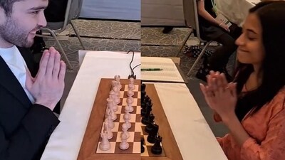 Nodirbek Yakubboev exchanges a 'Namaste' gesture with Indian GM Divya Deshmukh. (Twitter (ChessBase India))
