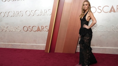 Lily-Rose Depp arrives on the Oscars red carpet in a black lace-embroidered gown featuring a plunging V neckline. (Jordan Strauss/Invision/AP) Lily-Rose Depp arrives on the Oscars red carpet in a black lace-embroidered gown featuring a plunging V neckline. (Jordan Strauss/Invision/AP)