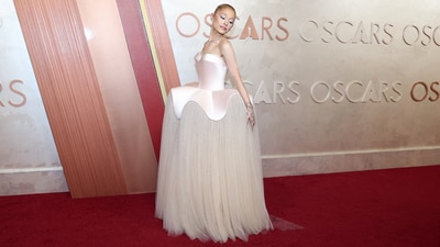 Ariana Grande poses on the red carpet during the Oscars arrivals. The Wicked star, also the Best Supporting Actress nominee, gave a nod to her character Glinda’s bubble dress in Wicked with a custom Schiaparelli gown. The structural gown features a satin bodice with a peplum design and a twinkling tulle skirt.&nbsp; (REUTERS)