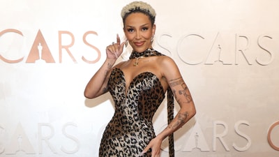 Doja Cat poses during the Oscars arrivals. The singer and rapper embodies her namesake for the red carpet in an animal-print Balmain gown covered in sequins. The plunging dress is based on a 1950s design by the house that was recreated for the singer.&nbsp; (REUTERS)