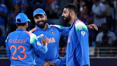 India's Varun Chakravarthy (R) celebrates with teammates after taking the wicket of New Zealand's captain Mitchell Santner. (AFP) India's Varun Chakravarthy (R) celebrates with teammates after taking the wicket of New Zealand's captain Mitchell Santner. (AFP)