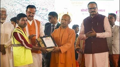 Chief minister Yogi Adityanath felicitating a municipal worker after the conclusion of Maha Kumbh in Prayagraj. (PTI) Chief minister Yogi Adityanath felicitating a municipal worker after the conclusion of Maha Kumbh in Prayagraj. (PTI)