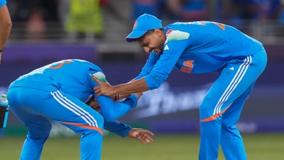 Virat Kohli tries to touch the feet of Axar Patel who dismissed Kane Williamson during the ICC Champions Trophy match between India and New Zealand (PTI) Virat Kohli tries to touch the feet of Axar Patel who dismissed Kane Williamson during the ICC Champions Trophy match between India and New Zealand (PTI)