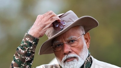 PM Modi was seen wearing a safari outfit and holding a camera to take shots of Gir's Asiatic lions. (X/@narendraModi) PM Modi was seen wearing a safari outfit and holding a camera to take shots of Gir's Asiatic lions. (X/@narendraModi)