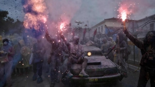 Revellers hold flares as they take part in "flour wars" during "Ash Monday," a traditional festivity marking the end of the carnival season and the start of the 40-day Lent period until the Orthodox Easter, in the port town of Galaxidi. (Louisa Gouliamaki / AFP) Revellers hold flares as they take part in "flour wars" during "Ash Monday," a traditional festivity marking the end of the carnival season and the start of the 40-day Lent period until the Orthodox Easter, in the port town of Galaxidi. (Louisa Gouliamaki / AFP)