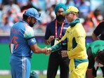 India captain Rohit Sharma, wearing a black armband, shakes hands with Australia's Steve Smith