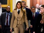 First lady Melania Trump walks through the Capitol wearing a three-piece tan suit. First lady Melania Trump walks through the Capitol wearing a three-piece tan suit.