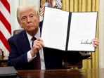 US President Donald Trump holds a signed executive order on cryptocurrencies, in the Oval Office of the White House, in Washington, U.S., January 23, 2025.