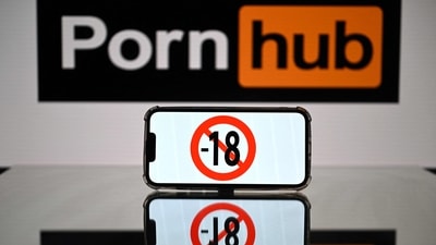 This photograph taken on May 24, 2022 in Toulouse shows screens displaying a minor child sign and the logo of the pornographic site Pornhub. (AFP)