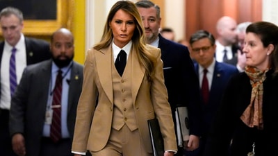 First lady Melania Trump walks through the Capitol wearing a three-piece tan suit. (AP) First lady Melania Trump walks through the Capitol wearing a three-piece tan suit. (AP)