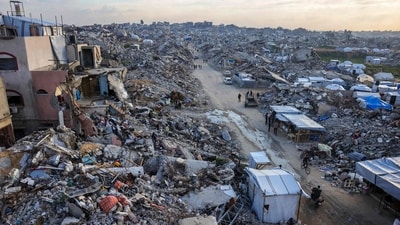 Palestinians walk amid the rubble of buildings in Beit Lahia in the northern Gaza Strip on March 4, 2025, amid the ongoing truce between Israel and Hamas. UN chief Antonio Guterres said he strongly endorsed an Egyptian plan put to Arab leaders at a summit in Cairo on March 4 for Gaza's reconstruction without displacement of its Palestinian inhabitants. (AFP) Palestinians walk amid the rubble of buildings in Beit Lahia in the northern Gaza Strip on March 4, 2025, amid the ongoing truce between Israel and Hamas. UN chief Antonio Guterres said he strongly endorsed an Egyptian plan put to Arab leaders at a summit in Cairo on March 4 for Gaza's reconstruction without displacement of its Palestinian inhabitants. (AFP)