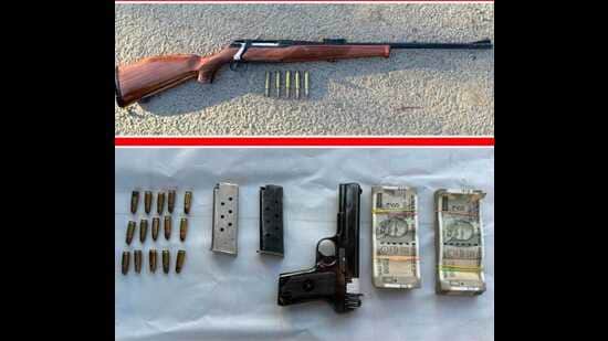 The weapons and drug money seized from the accused. (HT)
