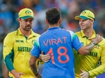 India's Virat Kohli with Australia's Travis Head and captain Steve Smith

