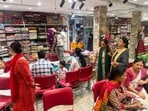 Shoppers crowd a textile store in Lucknow. (HT Photo)
