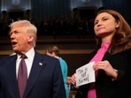 President Donald Trump arrives for his speech to a joint session of Congress as Rep. Melanie Stansbury (D-NM) holds a sign reading "This is not normal" at the U.S. Capitol on March 04, 2025 in Washington, DC.