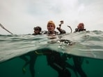 Divers rest after collecting trash off the coast of Hon Mot Island(AP)